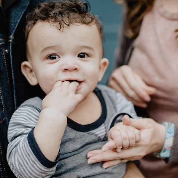 baby chewing on fingers
