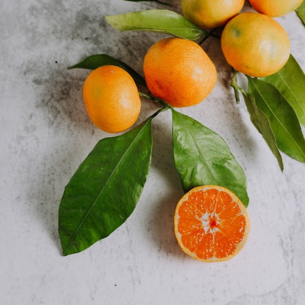 orange fruits on white surface