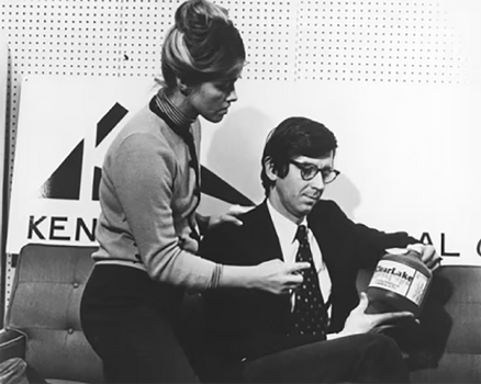 Woman and man holding container